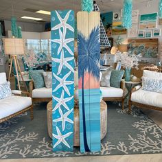 two surfboards are on display in a room filled with furniture and decorating items