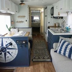 the interior of an rv with blue and white decor