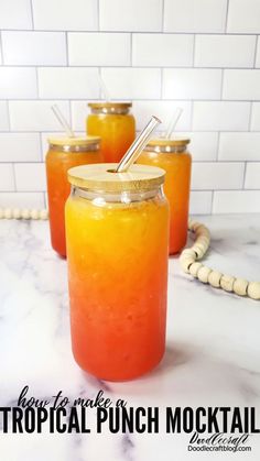 three jars filled with liquid sitting on top of a counter next to a white tile wall