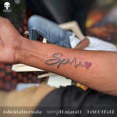 a person with a tattoo on their arm that says spam and has hearts in it