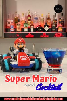 This image shows a blue drink with a red bottom sitting next to mario on a race car in front of a red lighted bar shelf. Mixology Drinks, Fruity Alcohol Drinks, Super Mario Kart, Classic Video