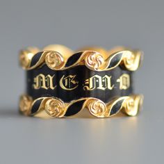 "A fantastic antique Victorian Era (1837-1901) wide mourning band ring with black enamel in 18k yellow gold. An extremely crisp and in excellent condition striking wide early Victorian period mourning ring with the central panel featuring classic gold gothic letting \"IN MEMORY OF\" and flooded with glossy black enamel, the top and bottom features swirling cartouches with black enamel and gold roses or flowers. The interior of the band is hand engraved with \"Tho's Latham died 3rd March 1843 Aet Victorian Yellow Gold Enamel Ring, Victorian Yellow Gold Enamel Ring For Formal Occasions, Victorian Gold Enamel Ring, Victorian Style Hallmarked Enamel Ring In Yellow Gold, Victorian Gold Enamel Ceremonial Ring, Black Heirloom Ceremonial Jewelry, Formal Black Engraved Ring With Black Enamel, Black Heirloom Jewelry For Ceremonial Occasions, Black Heirloom Jewelry For Ceremonial Use