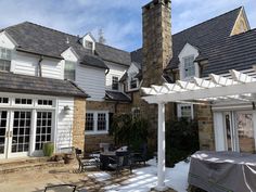 a house with a covered patio next to it's front door and side entrance