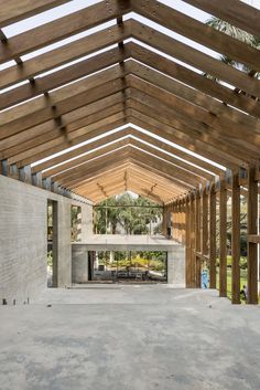 the inside of a building with wooden beams