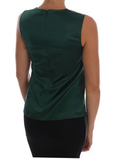 Indulge in the luxury and sophistication of a Dolce & Gabbana creation with this exquisite sleeveless silk top. Elegant in its design, this blouse is crafted with a sumptuous blend of 96% silk and 4% elastane, ensuring both comfort and a flattering fit. The dark green hue lends a touch of refined charm to any ensemble, making it a perfect piece for both casual and formal occasions. Adorned with subtle logo details, it embodies the brand’s commitment to luxurious detailing. Material: 96% Silk, 4% Silk Sleeveless Top, Green Logo, Blouse Material, Dolce E Gabbana, Green Silk, Dolce & Gabbana, Sleeveless Tank Top, Silk Top, Sleeveless Tank