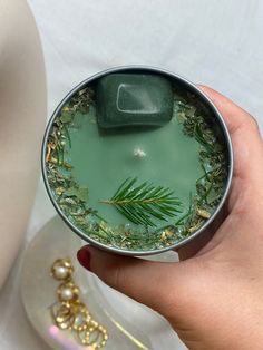 a person holding a cup filled with green liquid