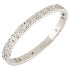 CARTIER LOVE BRACELET Cartier 'Love' bangle bracelet crafted in 18 karat white gold with diamond screw tops and pave set round brilliant cut diamonds (D-F in color, VVS clarity) Signed Cartier, 17, 750, with serial number and hallmarks The bracelet is presented with a Cartier box and certificate upon sale In 18k white gold and pavé of diamonds total 3.70ct In size 17 Original at shop at 67.500€ If the robust locking mechanism and miniature screw heads that characterized Cartier’s Love bracelet w Love Bracelet Cartier, Cartier Diamond Bracelet, Cartier White Gold, Cartier Love Bangle, Bracelet Cartier, European Jewelry, David Webb, French Jewelry, Bracelet Love