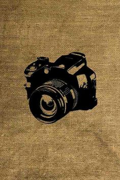 a camera drawn on the side of a burlocked piece of cloth with black ink