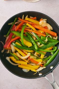 stir fry vegetables are being cooked in a wok