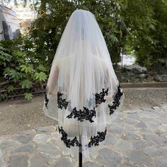 the back of a wedding veil with black appliques