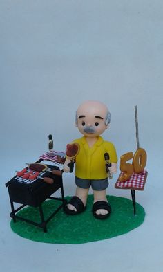 a figurine is standing in front of a table with a grill and chair