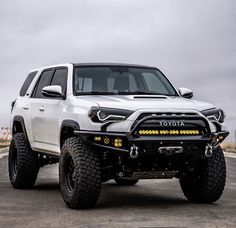 a white toyota truck parked on top of a parking lot