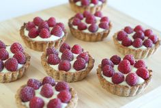 cupcakes decorated with raspberries, blueberries and chocolate on a table