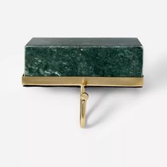 a green marble box with gold handles on a white background