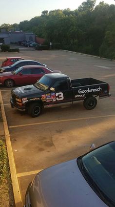 two trucks parked next to each other in a parking lot