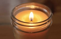 a close up of a lit candle on a table