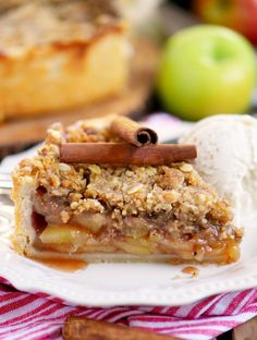 a slice of apple pie on a plate with ice cream