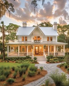 a white house surrounded by trees and grass