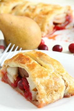 a piece of pie on a plate with a fork and cranberry sauce next to it