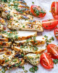 grilled chicken with tomatoes and parsley on the side is shown in this postcard