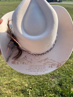 Saddle up in style with our custom engraved western hat, designed exclusively for women who embrace the country vibe in their wardrobe. Crafted with high-quality materials and adorned with intricate engravings, this hat adds a touch of rustic charm to any outfit. Each hat is handcrafted to perfection, ensuring a unique piece that reflects your individual style. The personalized engraving allows you to add your name, initials, or a special message, making it a one-of-a-kind accessory that speaks to your personality. Whether you're headed to a concert, celebrating a birthday, or simply going about your day, this hat is the perfect finishing touch to elevate your look. Embrace your inner cowgirl and let your style shine with our custom engraved western hat for women. Key Features: Custom engr Country Style Flat Bill Hat For Country Events, Custom Felt Hat For Country Events, Custom Flat Brim Felt Hat For Western-themed Events, Custom Flat Brim Fedora For Western-themed Events, Custom Adjustable Felt Hat For Western-themed Events, Custom Felt Hat For Rodeo, One Size, Custom White Hat For Rodeo, Custom White Rodeo Hat, Adjustable Custom Top Hat For Country Events