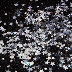 many shiny stars are scattered in the dark night sky, creating an abstract pattern on this black background