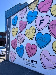 a large mural on the side of a building with many hearts painted all over it