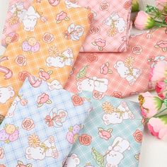 four different patterns of fabric with flowers and animals on them, all in pastel colors