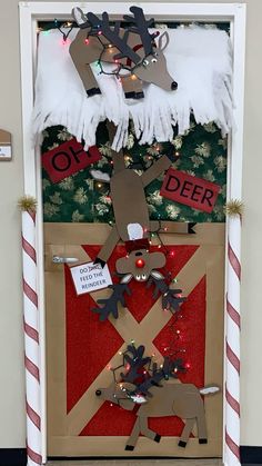 a door decorated with reindeers and christmas lights