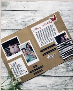 a scrapbook with pictures and words on it sitting on a wooden table next to flowers