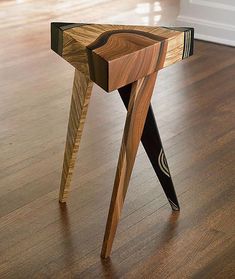 a wooden table sitting on top of a hard wood floor