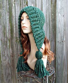 a mannequin head wearing a green knitted hat