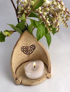 a small candle holder with a butterfly on it