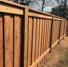 a wooden fence in front of a house