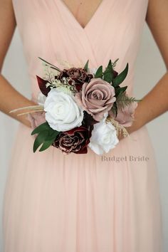 a bridesmaid in a pink dress holding a bouquet with white and burgundy flowers