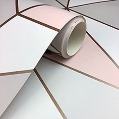 a roll of pink and white tape sitting on top of a wall