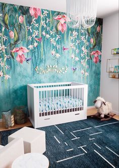 a baby's room decorated in blue and pink