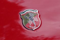 an emblem on the side of a red car