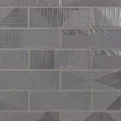 a close up view of a wall made out of squares and rectangles in grey