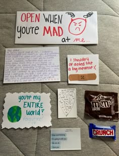 some paper and stickers on a bed with the words open when you're mad at me