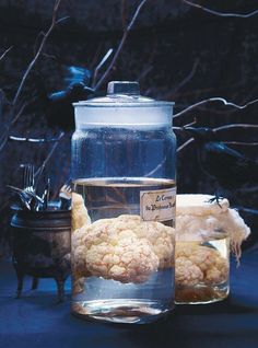 there is a glass jar filled with cauliflower next to other items on the table