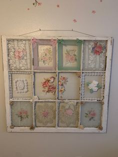 an old window is decorated with flowers and lace