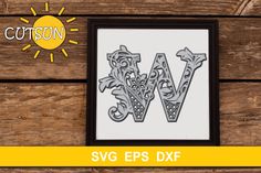 the letter v is made out of wood and has an ornate design on it, with sun