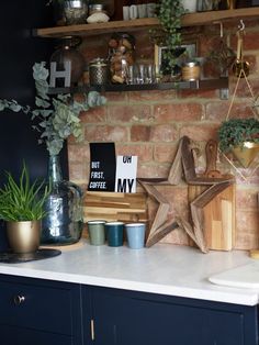 a kitchen counter with pots and plants on it, along with other items such as wooden stars