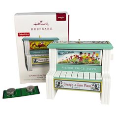 a toy piano with its box and instructions