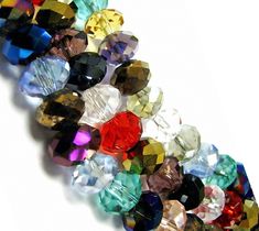 many different colored stones on a white surface