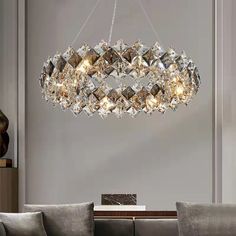 a chandelier hanging from the ceiling in a living room