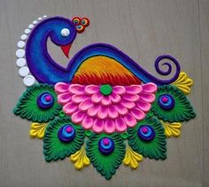 a colorful peacock is sitting on top of a table