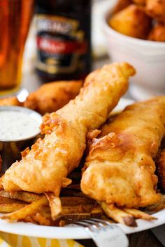 fried fish and fries on a plate with dipping sauce