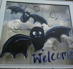 a welcome sign with bats painted on it